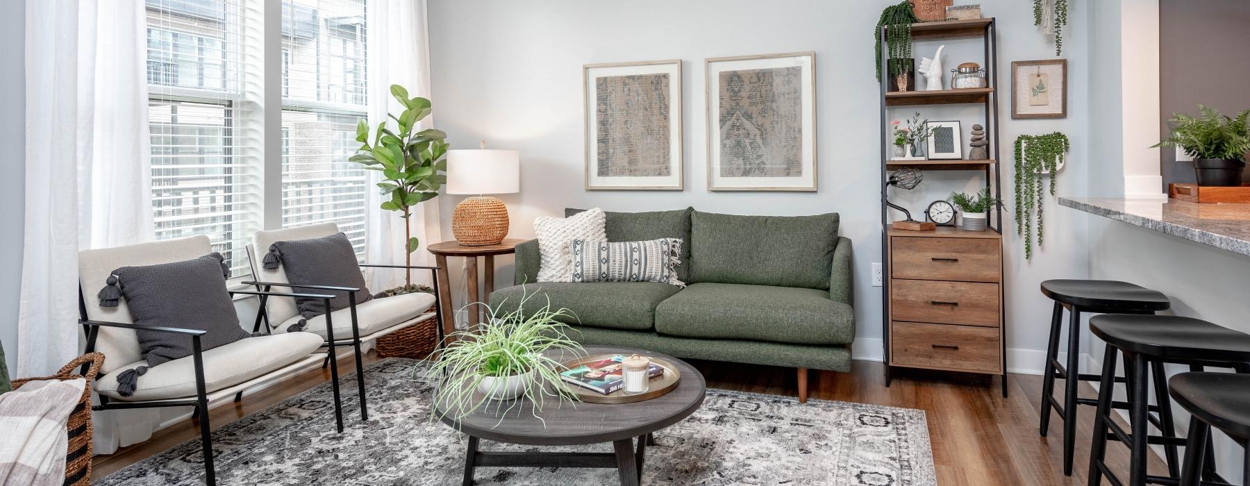 a living room with a green couch and a coffee table