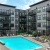 a swimming pool in a courtyard between buildings
