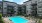 a swimming pool in a courtyard between buildings