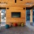 a room with a brick patio and a brick patio with a brick patio and a large screen and